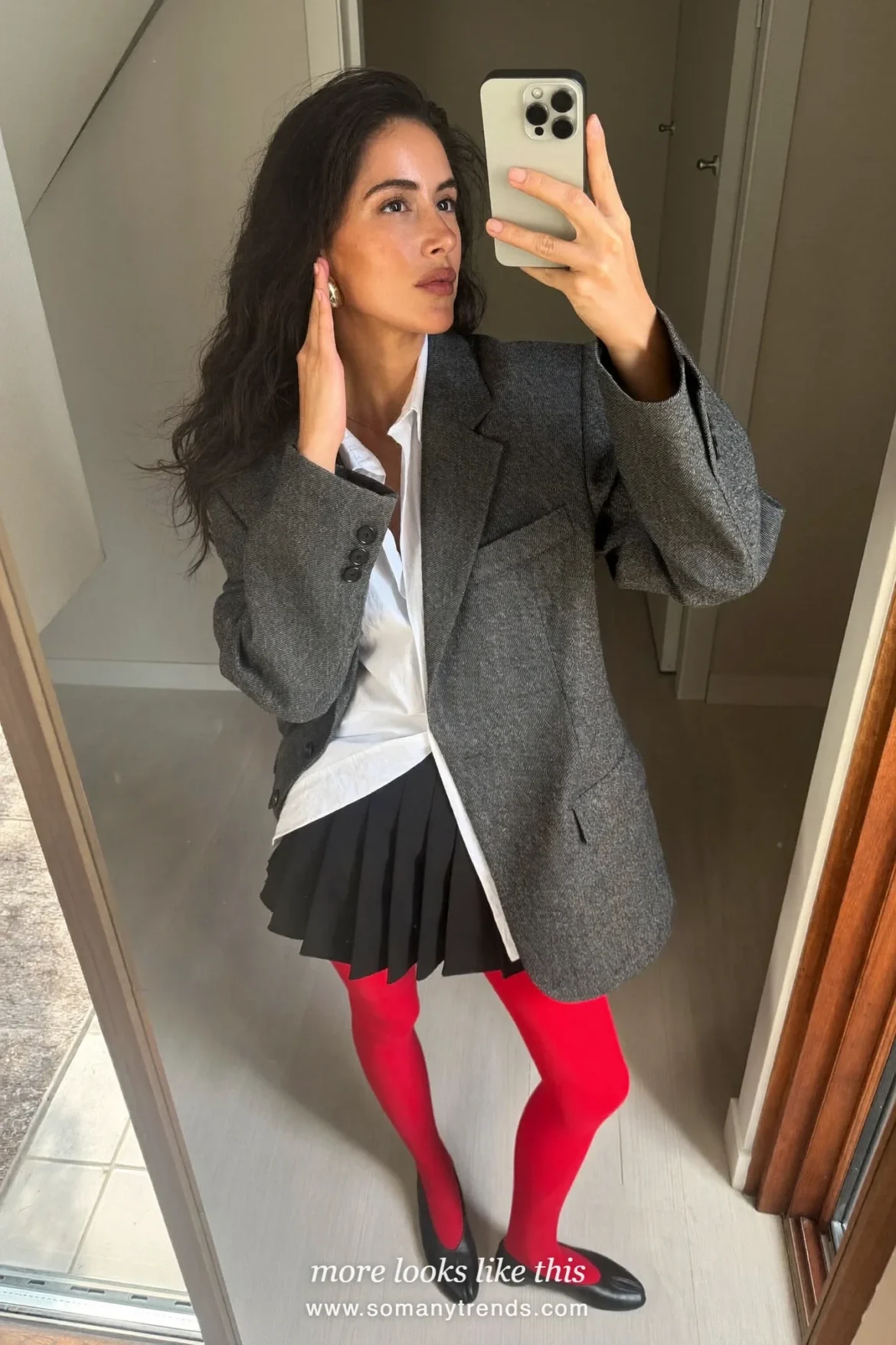 Woman in an oversized gray wool blazer, black pleated mini skirt, red opaque tights and black ballet flats, outfit 15