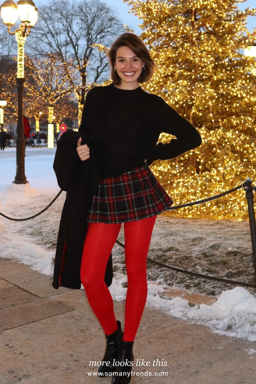 Woman in a black sweater, black and red tartan midi skirt, red opaque tights and black ankle boots, outfit 19