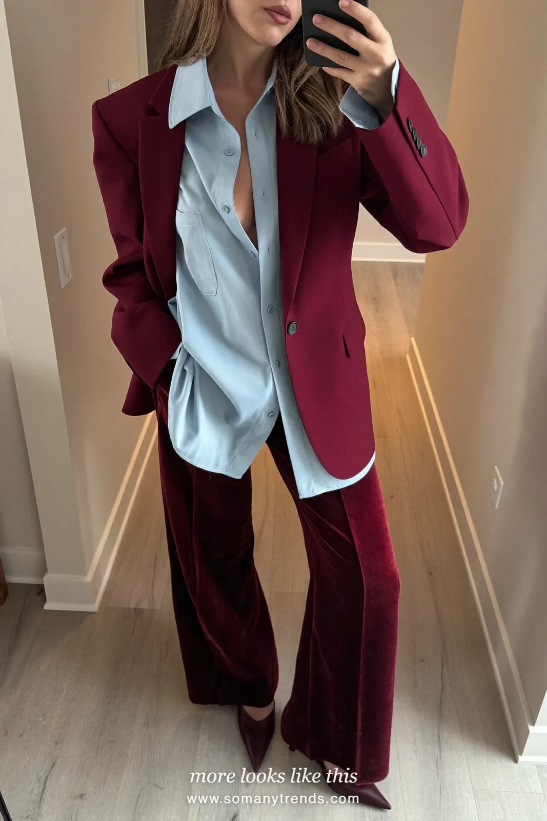 Woman in a burgundy velvet oversized blazer, an icy blue silk shirt, burgundy velvet wide-leg pants and burgundy pumps, outfit 3