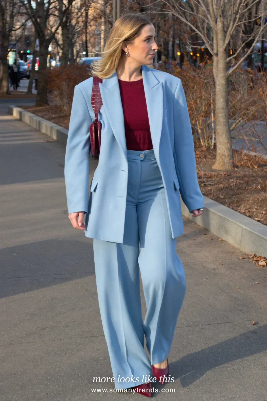 Woman in a powder blue oversized suit, a burgundy knit top, a burgundy croc bag and burgundy pumps, outfit 7