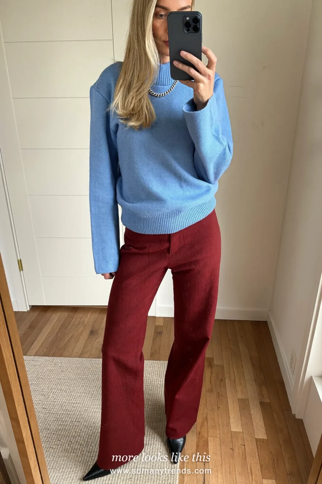 Woman in a baby blue fine knit sweater, burgundy wide-leg pants and black pointed boots, outfit 12