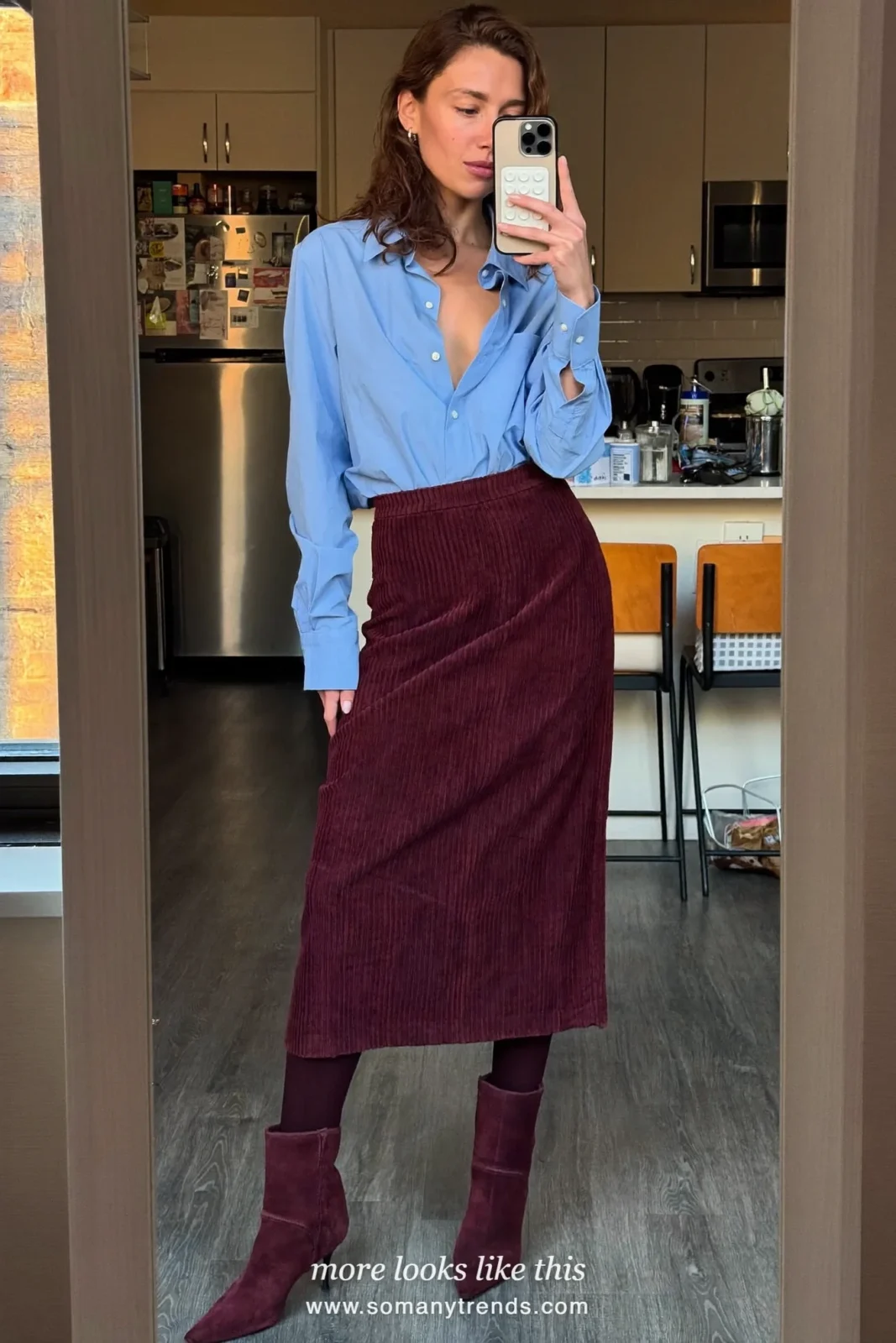 Woman in a baby blue poplin shirt, a burgundy corduroy midi skirt, burgundy tights and burgundy suede boots, outfit 21