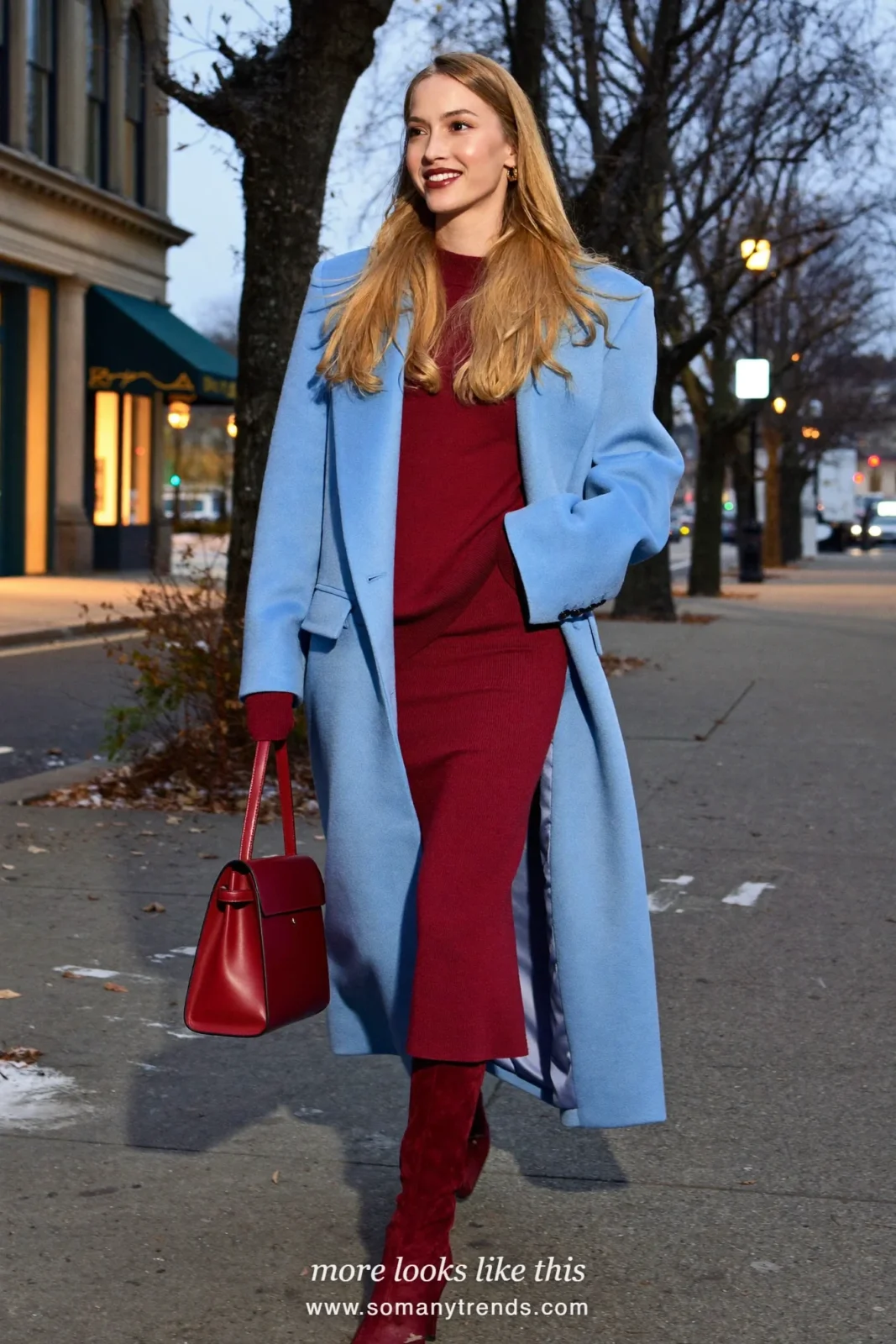 Woman in a baby blue long coat over a burgundy knit top and midi skirt set with burgundy suede boots, outfit 25