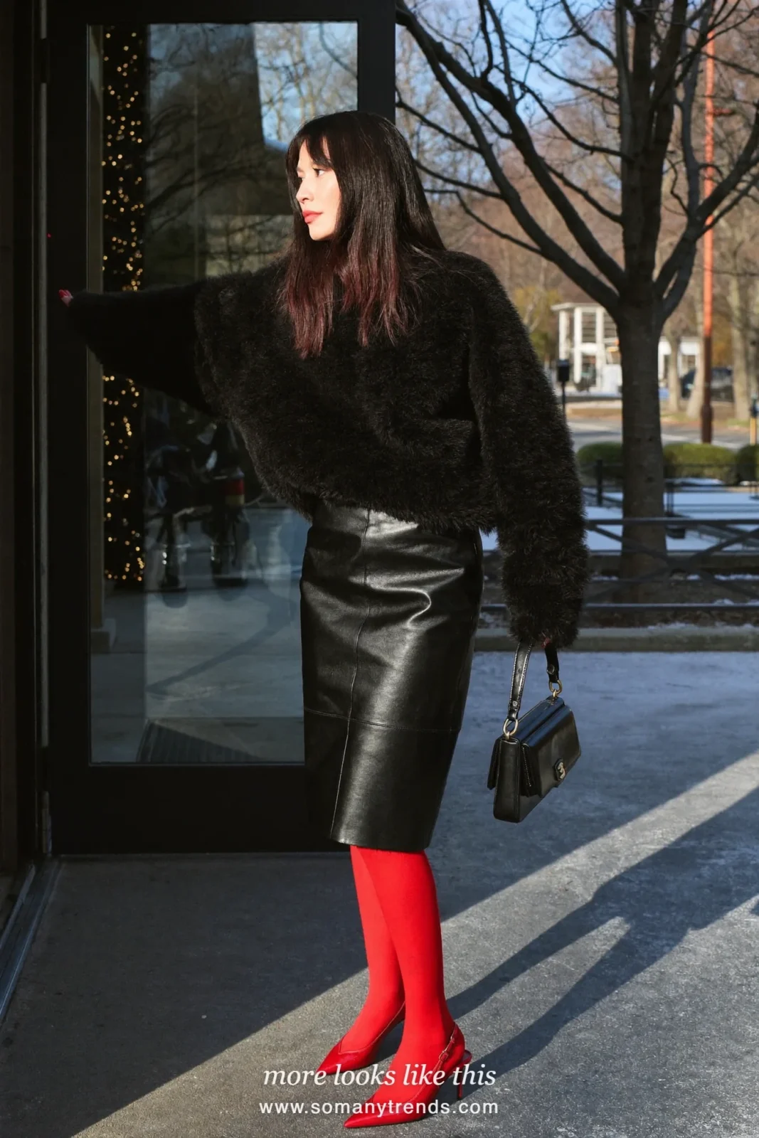 Woman in a black fuzzy sweater, black leather pencil midi skirt, bright red opaque tights and red patent slingbacks, outfit 1