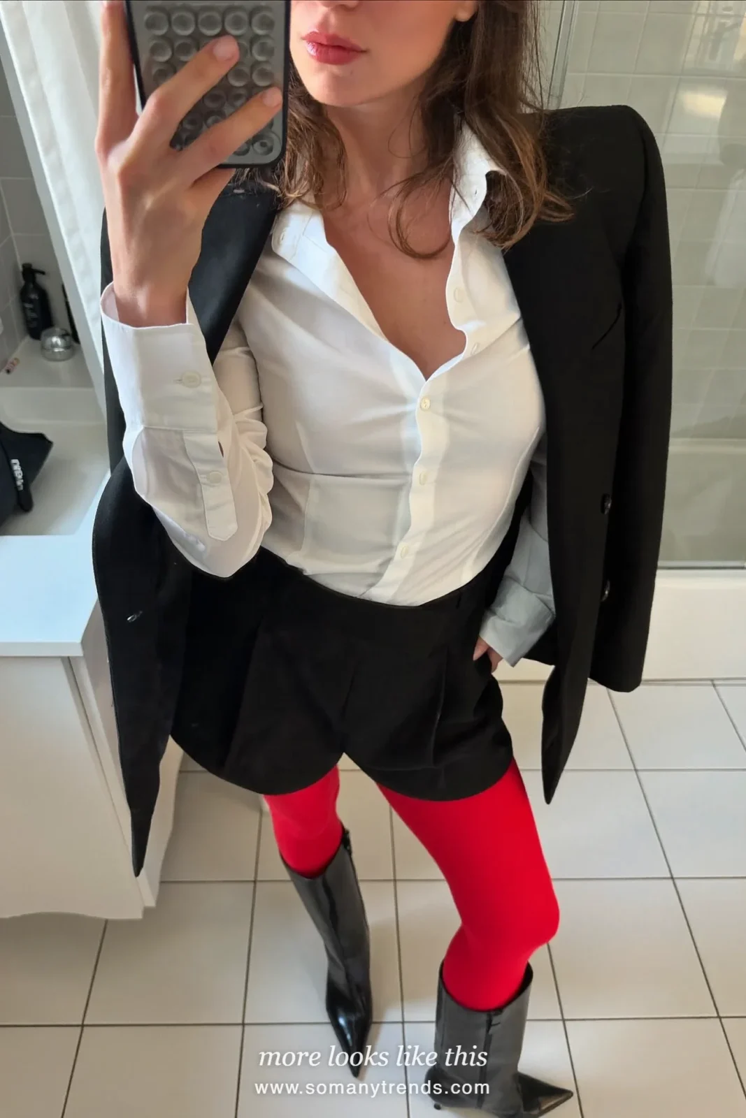 Woman in black tailored shorts, white shirt, long black coat, red opaque tights and black pointed boots, outfit 18
