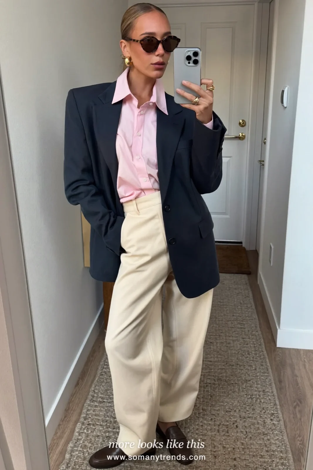 Woman in a navy blue blazer, pale pink shirt, cream wide-leg pants and brown loafers, outfit 9