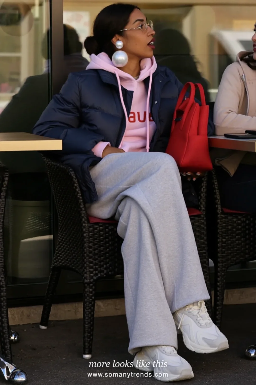 Woman in a navy blue puffer jacket, pink hoodie, gray sweatpants and white chunky sneakers, outfit 16