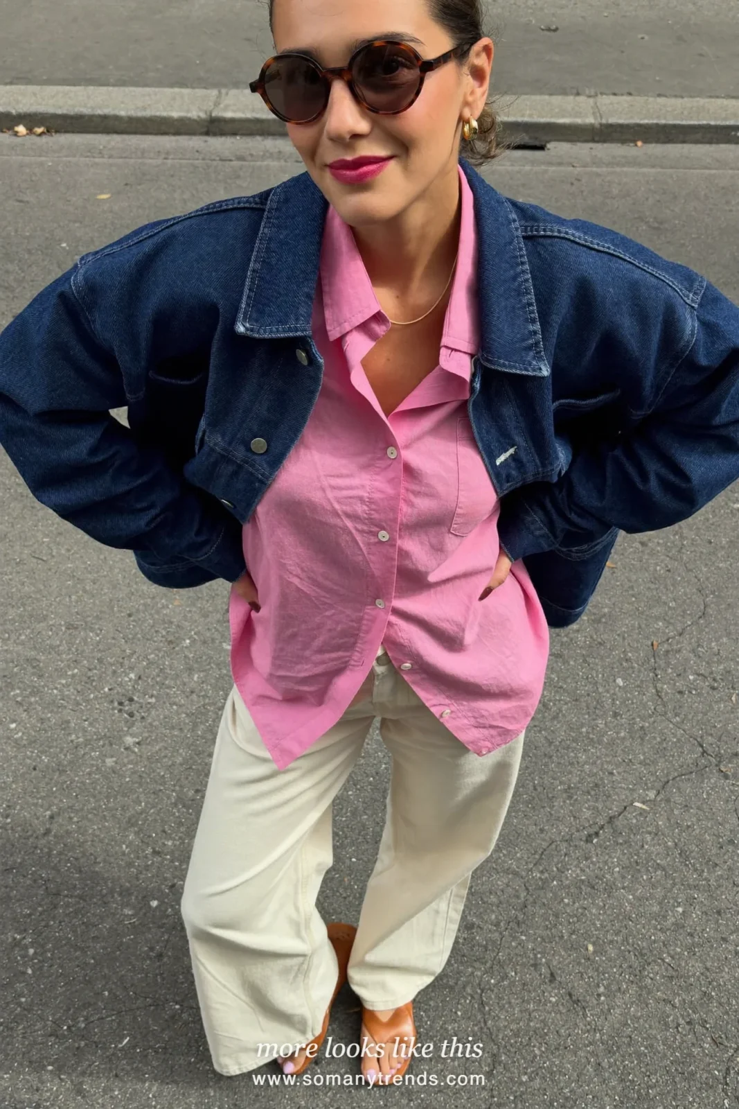 Woman in a navy blue denim jacket, pink linen shirt, cream pants and tan sandals, outfit 17