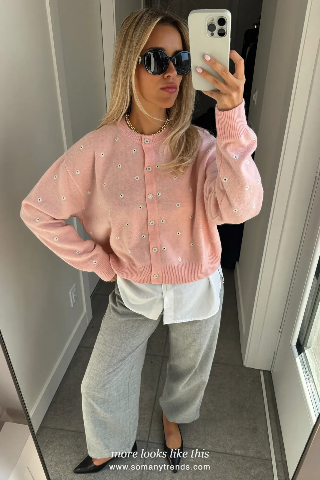 Pale pink cardigan with tiny white flowers over a white shirt with gray wide-leg pants and pointed black flats, outfit 18