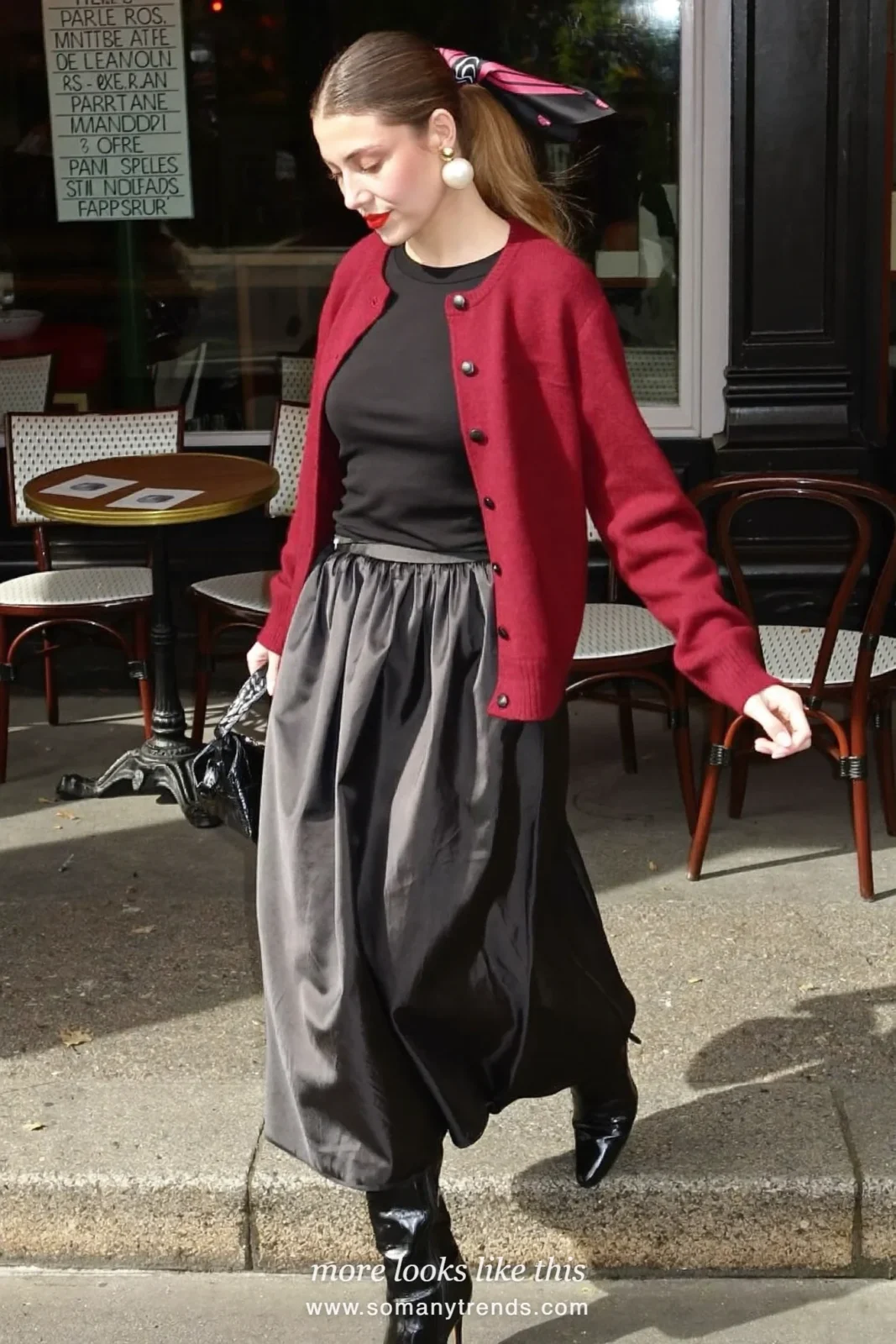 Burgundy cardigan over a black tee with a black satin midi skirt and tall black boots, outfit 19