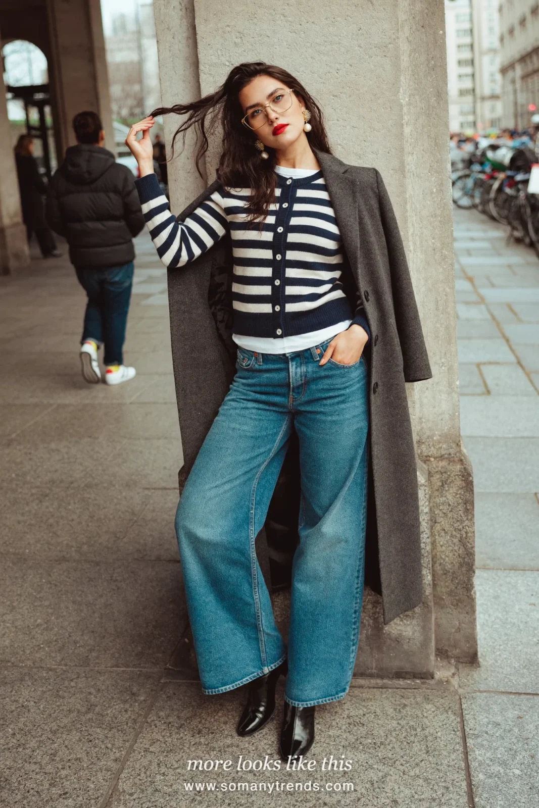 Charcoal long wool coat over a navy and cream striped cardigan with straight jeans and black ankle boots, outfit 24