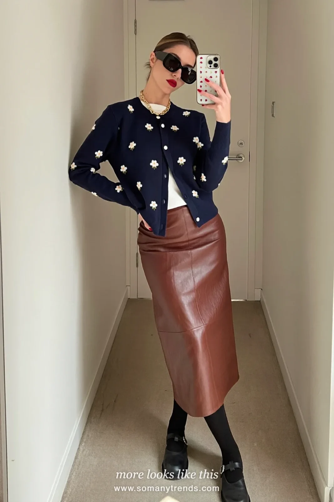 Navy cardigan with small flowers over a white tee with a brown leather midi skirt and black Mary Janes, mirror selfie in a hallway, outfit 26