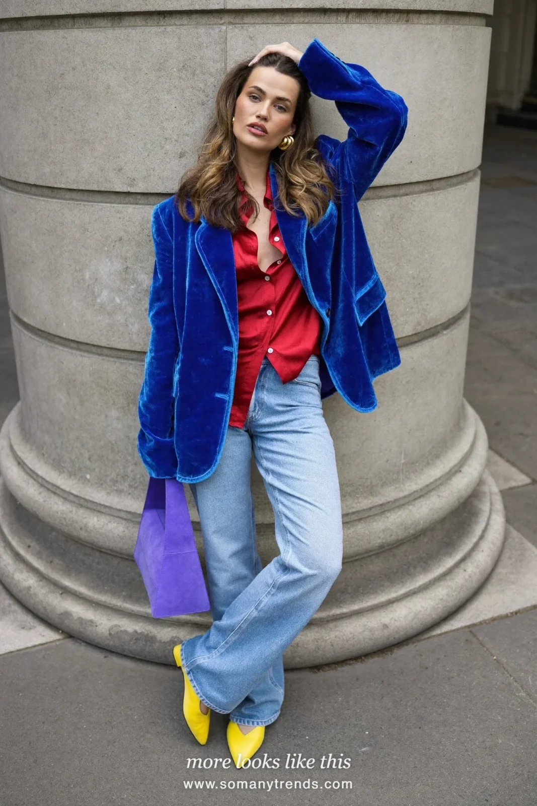Woman in a cobalt blue velvet blazer, cherry red silk shirt, light flared jeans, yellow pointed flats and violet bag, outfit 4