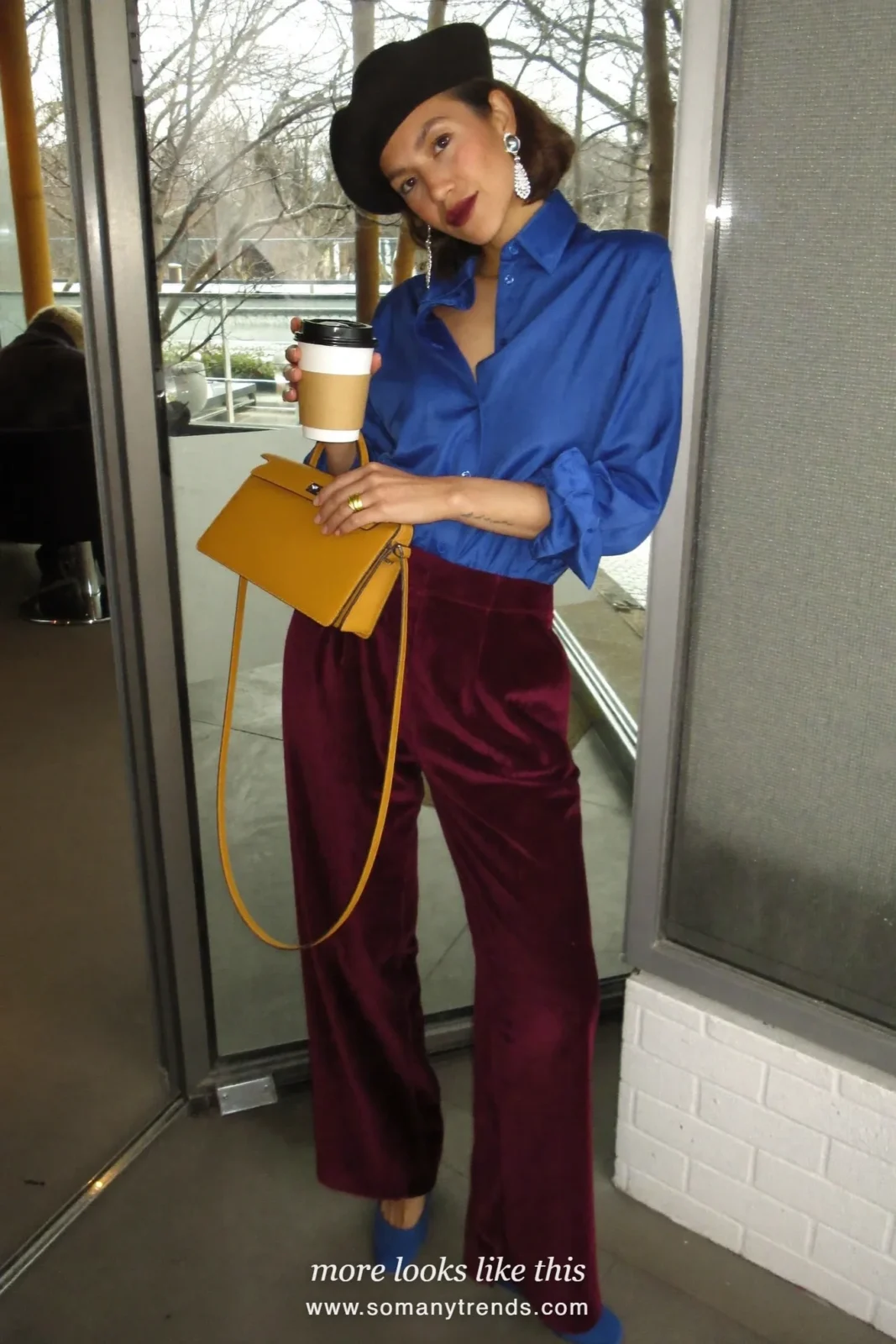 Woman in deep burgundy velvet wide pants, cobalt blue satin shirt, cobalt pumps and mustard bag, outfit 5