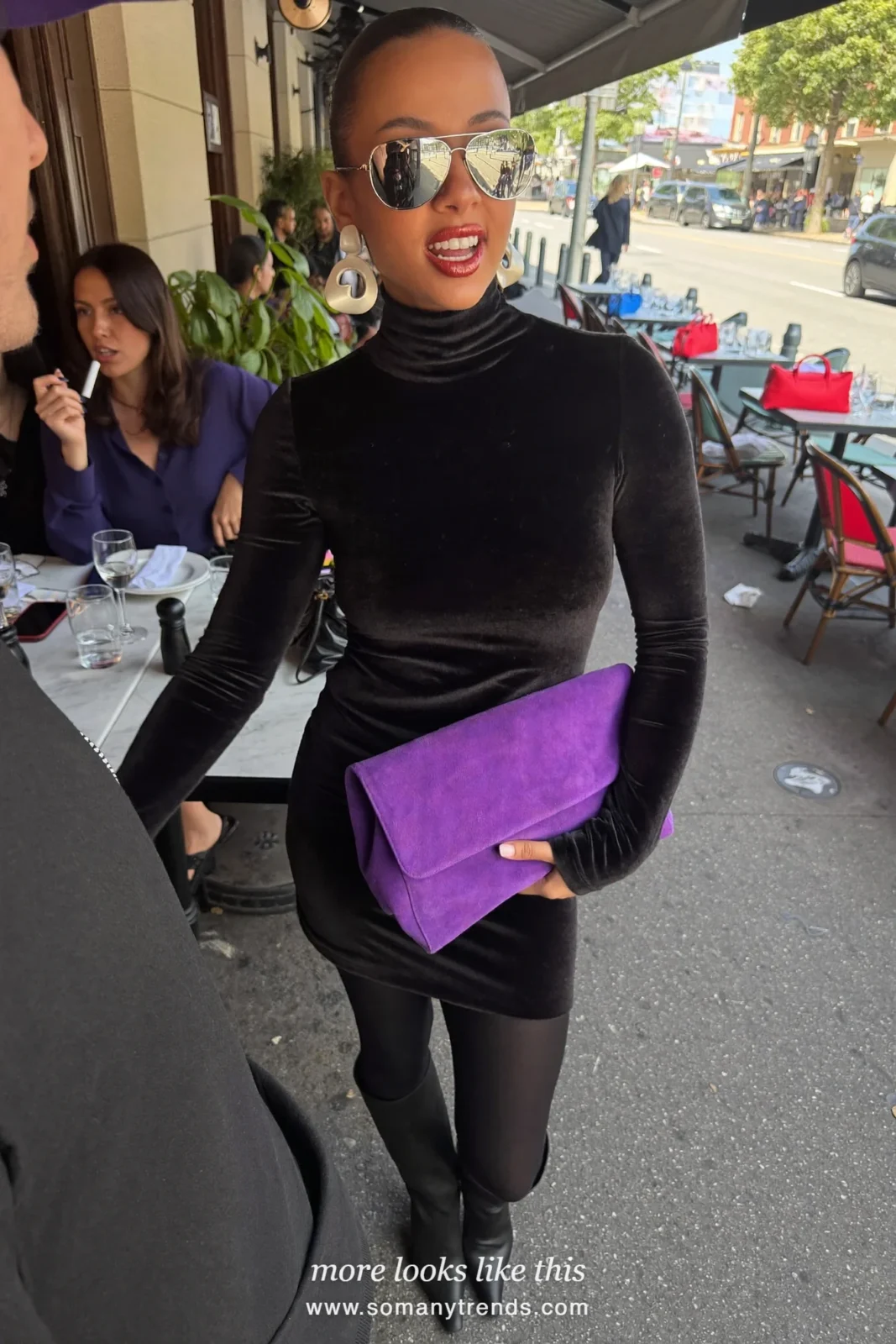 Woman in a black velvet turtleneck dress above the knee, burgundy opaque tights, black pointed boots and purple suede clutch, outfit 10