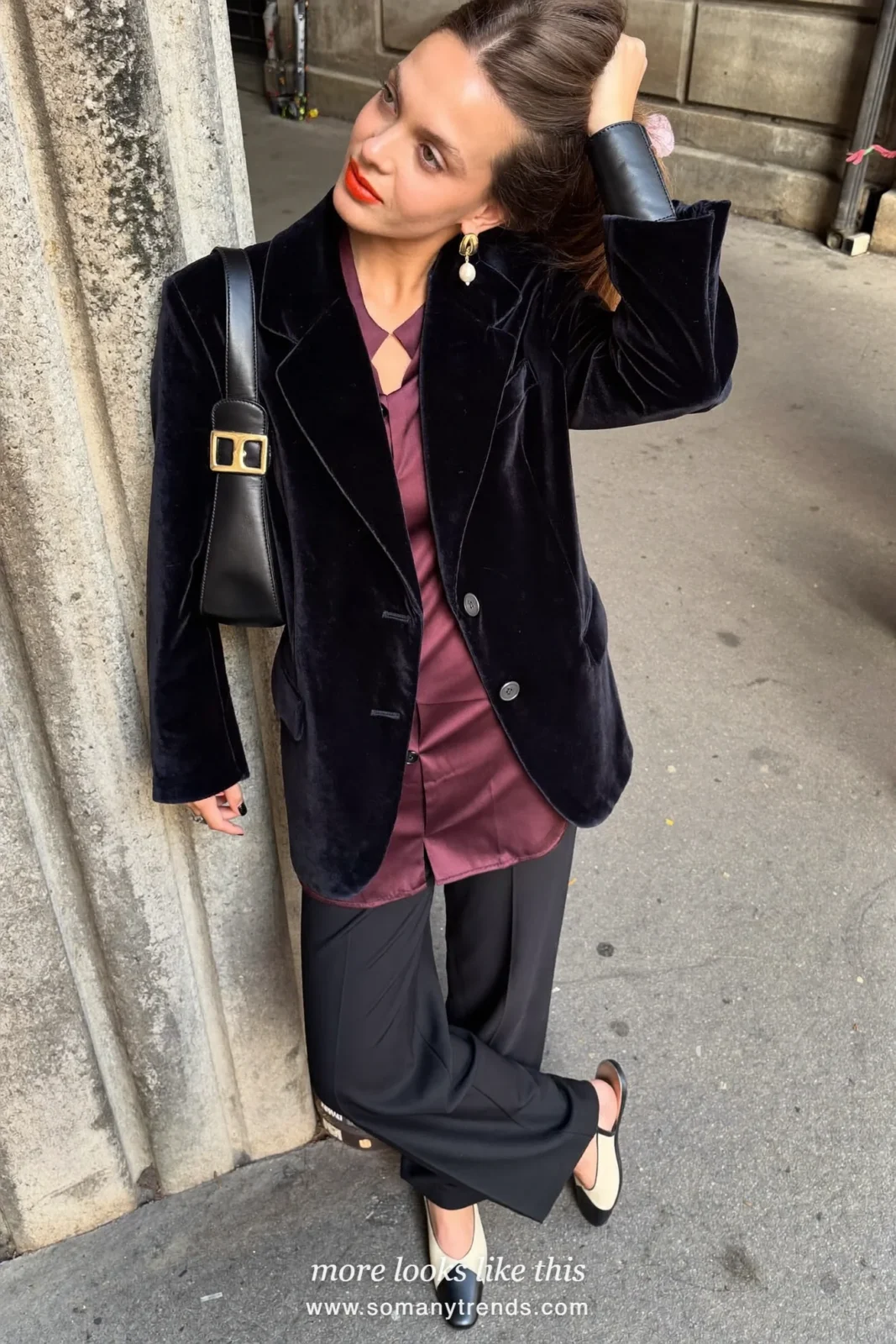 Woman in a black velvet blazer, burgundy satin shirt, black straight pants and cream and black slingbacks, outfit 14