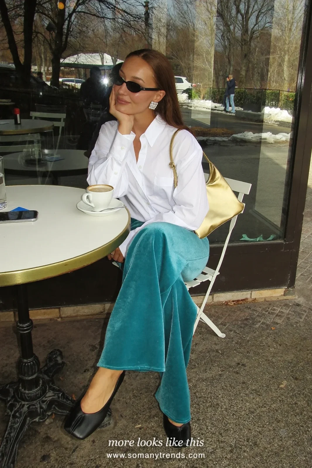 Woman in teal velvet wide pants, white poplin shirt, black flats and small gold bag, outfit 16
