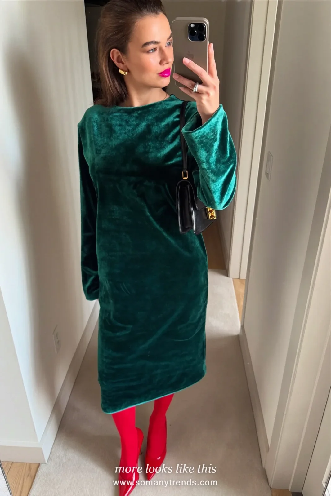 Woman in an emerald green velvet midi dress, sheer black tights and red patent pumps, outfit 18