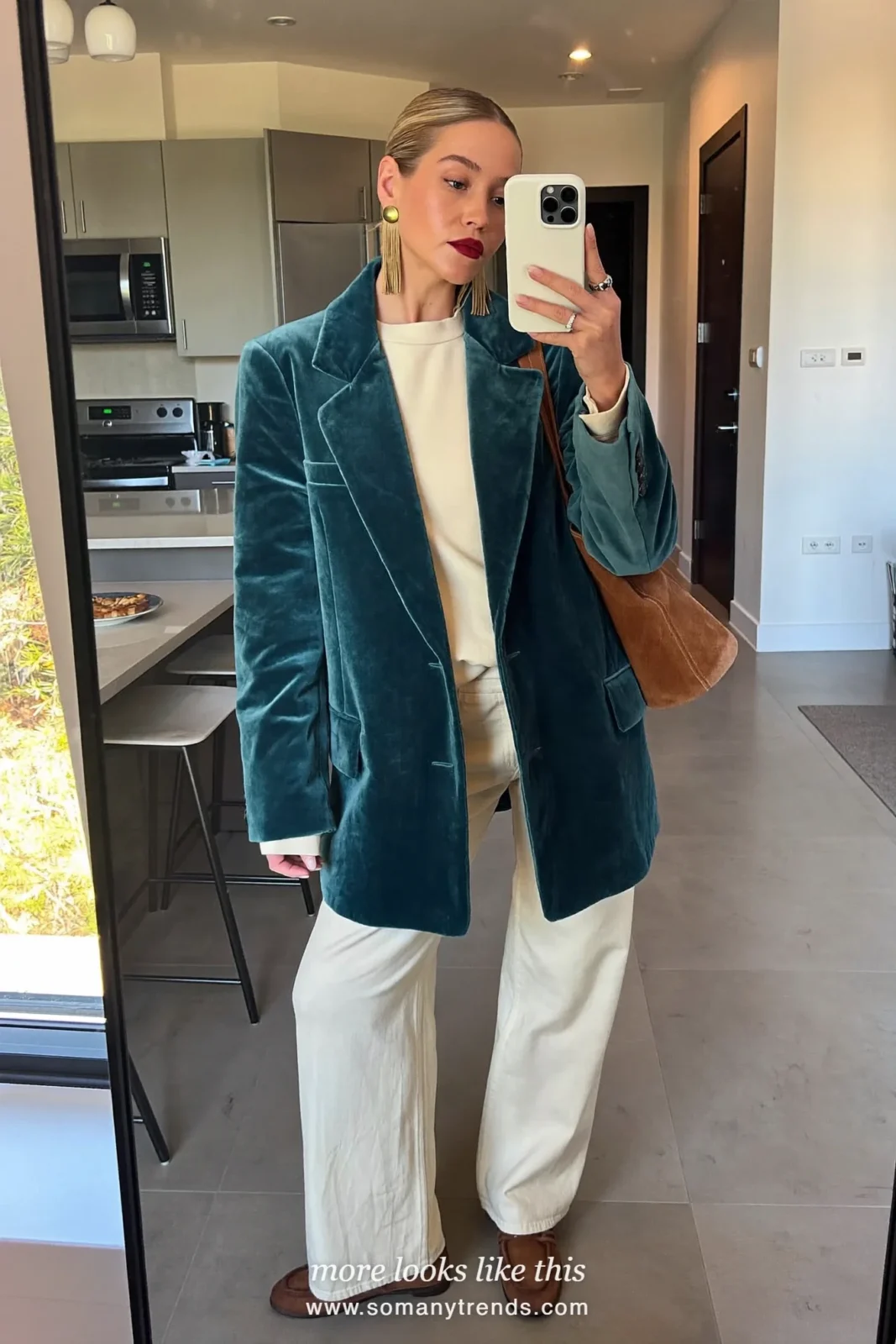 Woman in a teal velvet blazer, cream top, cream wide pants, brown loafers and brown bag, outfit 21