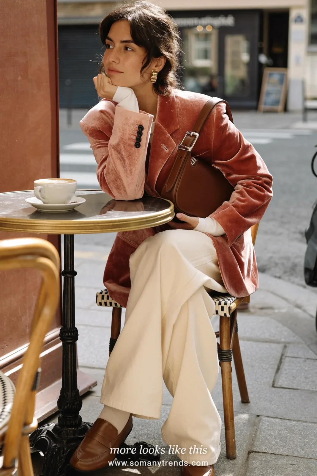 Woman in a rose pink velvet blazer, white top, cream jeans, tan loafers and chocolate brown bag, outfit 26
