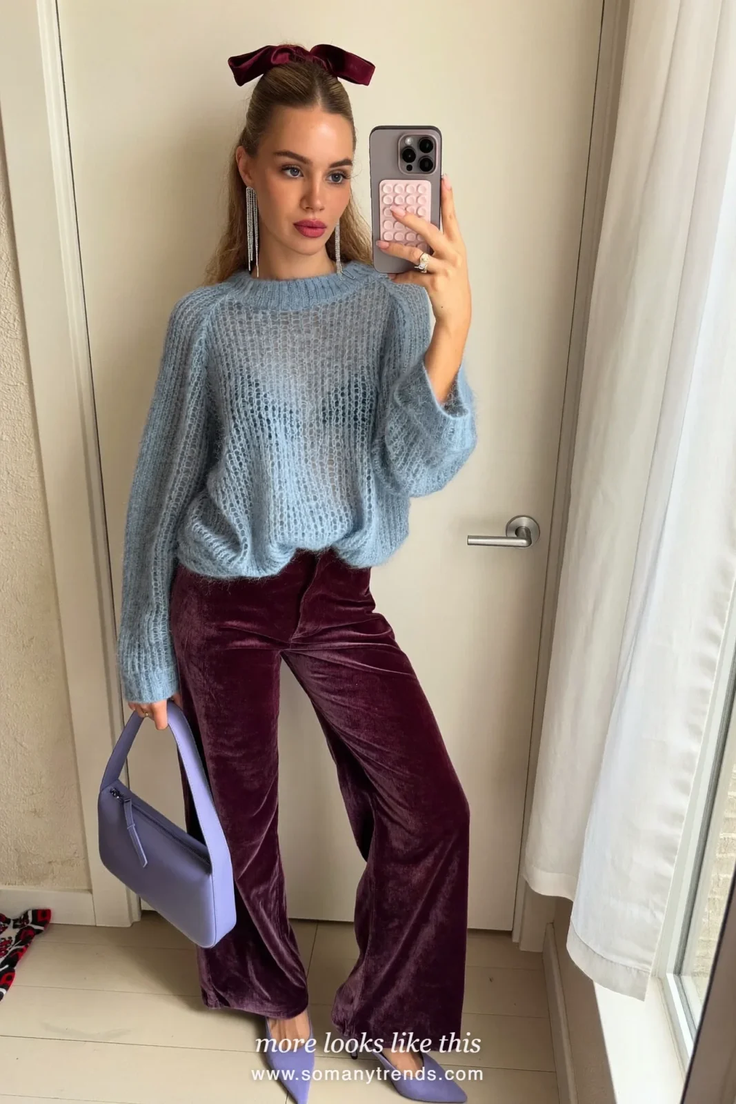 Woman in deep aubergine velvet wide pants, light blue chunky sweater, lilac pumps and periwinkle bag, outfit 9