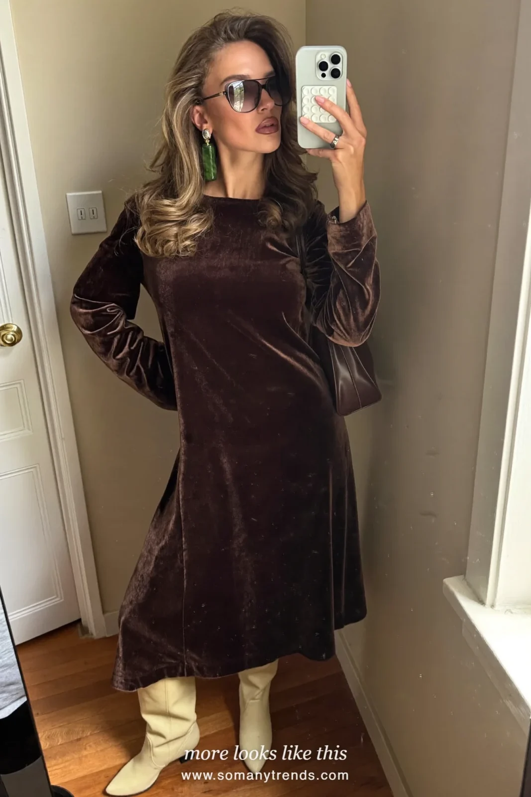 Woman in a dark chocolate brown velvet midi dress with long sleeves and cream tall boots, outfit 15