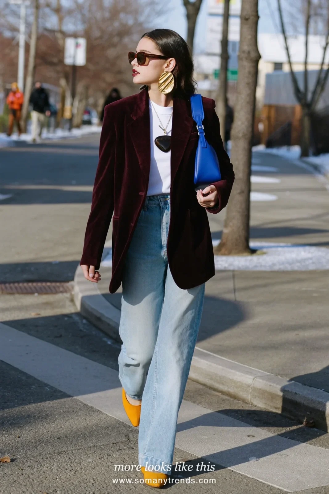 Woman in a deep burgundy velvet blazer, white tee, light straight jeans, mustard flats and cobalt bag, outfit 19