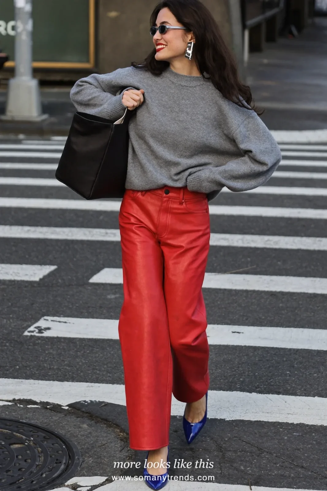 Woman in a gray cashmere sweater, red soft matte leather straight pants, cobalt blue patent pointed pumps and a black tote, look 2