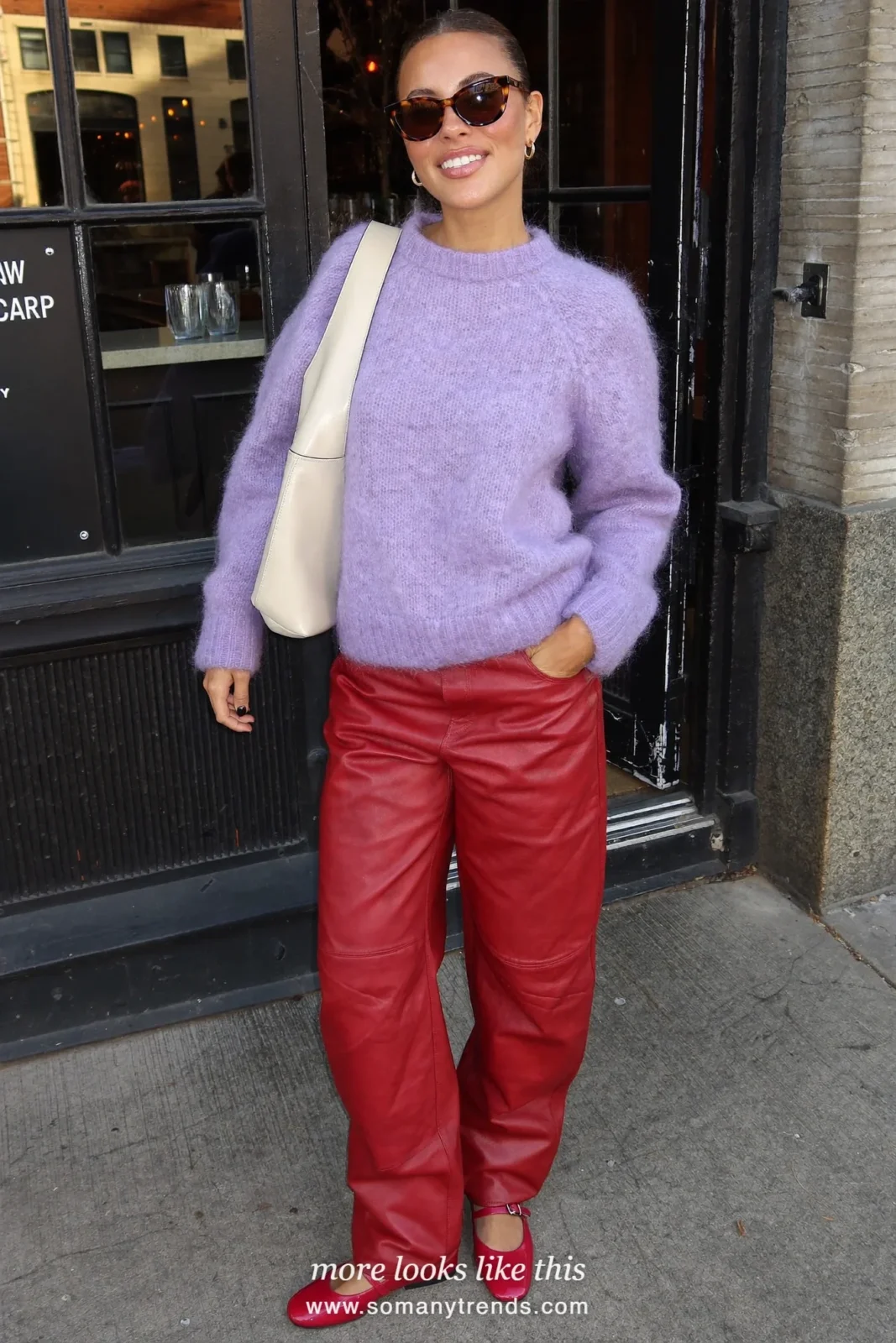 Woman in a lilac mohair sweater, red soft matte leather straight pants, pink patent Mary Janes and a cream bag, look 7
