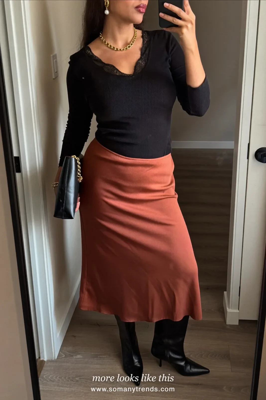 Black lace-trim top, rust satin midi skirt, black pointed knee-high boots and black clutch, outfit 18