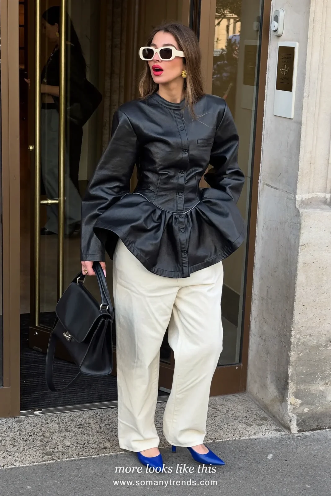 Petite woman in a black leather peplum top, wide cream trousers, cobalt blue pointed pumps and a black bag, outfit 5
