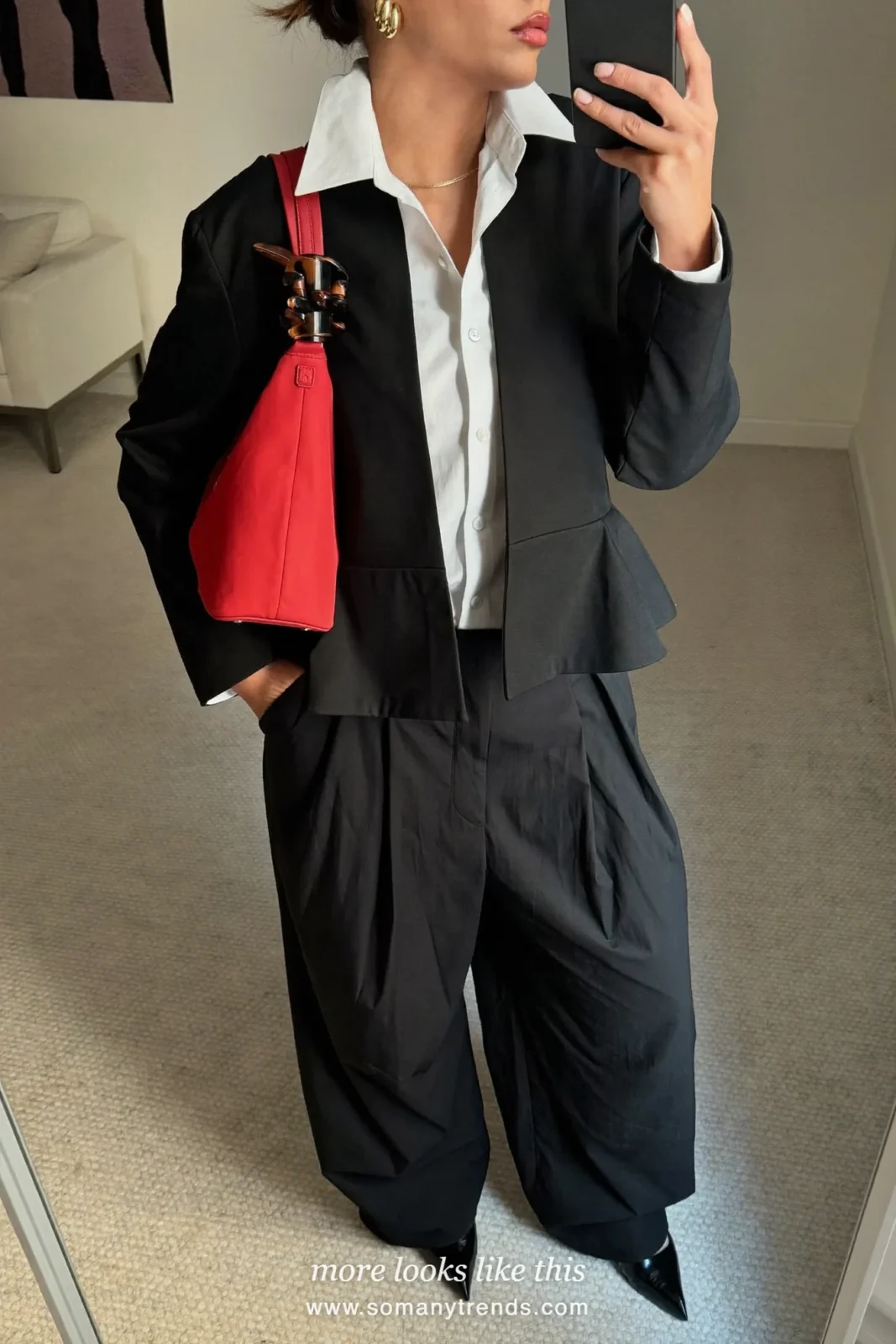 Petite woman in a black peplum jacket, white shirt, wide black pleated trousers, black pointed pumps and a cherry red Prada nylon bag, outfit 6