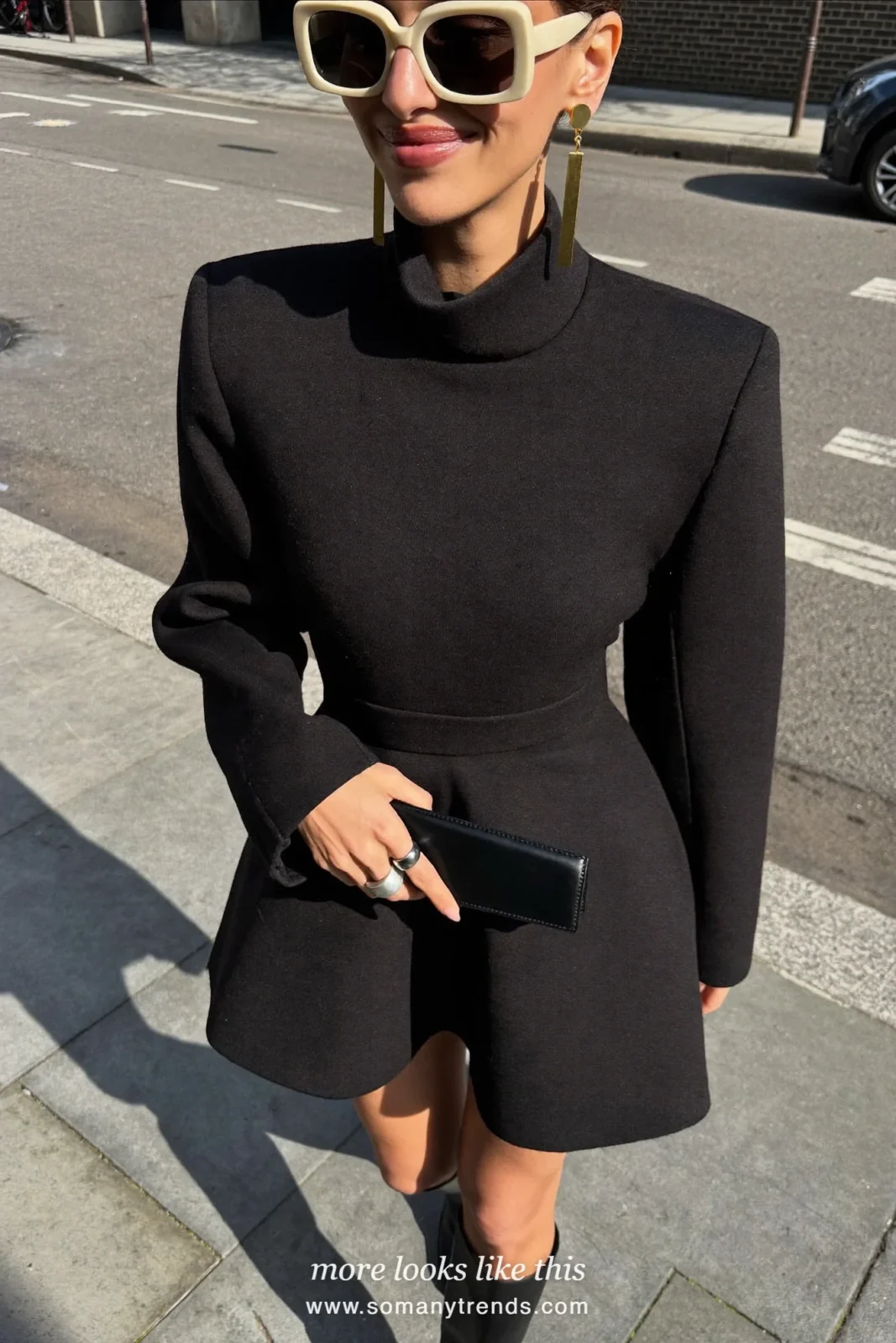 Petite woman in a black wool peplum coat-dress, sheer high-neck top and black knee boots, outfit 8