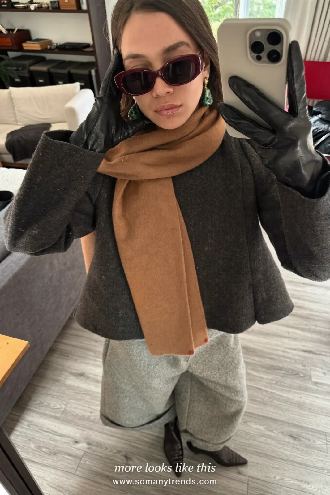 Petite woman in a fine wool peplum top, camel scarf, gloves, wide gray flannel pants and black pointed boots, outfit 15