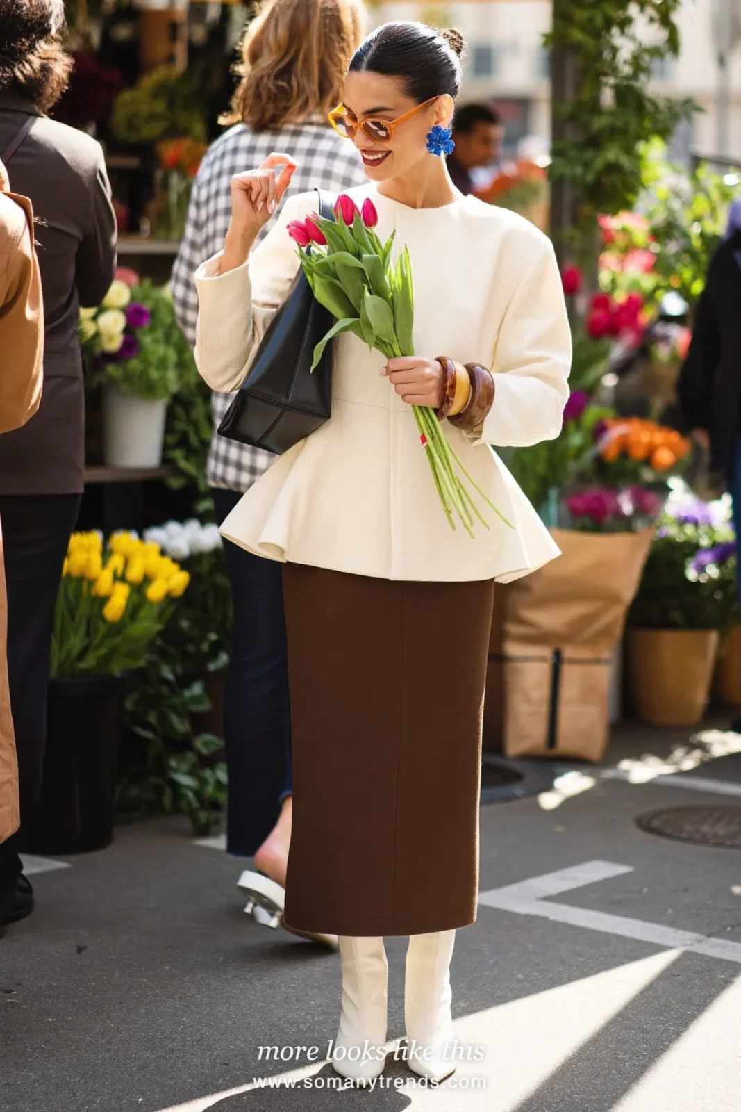 Petite woman in a cream peplum jacket, chocolate column skirt, chocolate pointed boots and a black bag, outfit 17