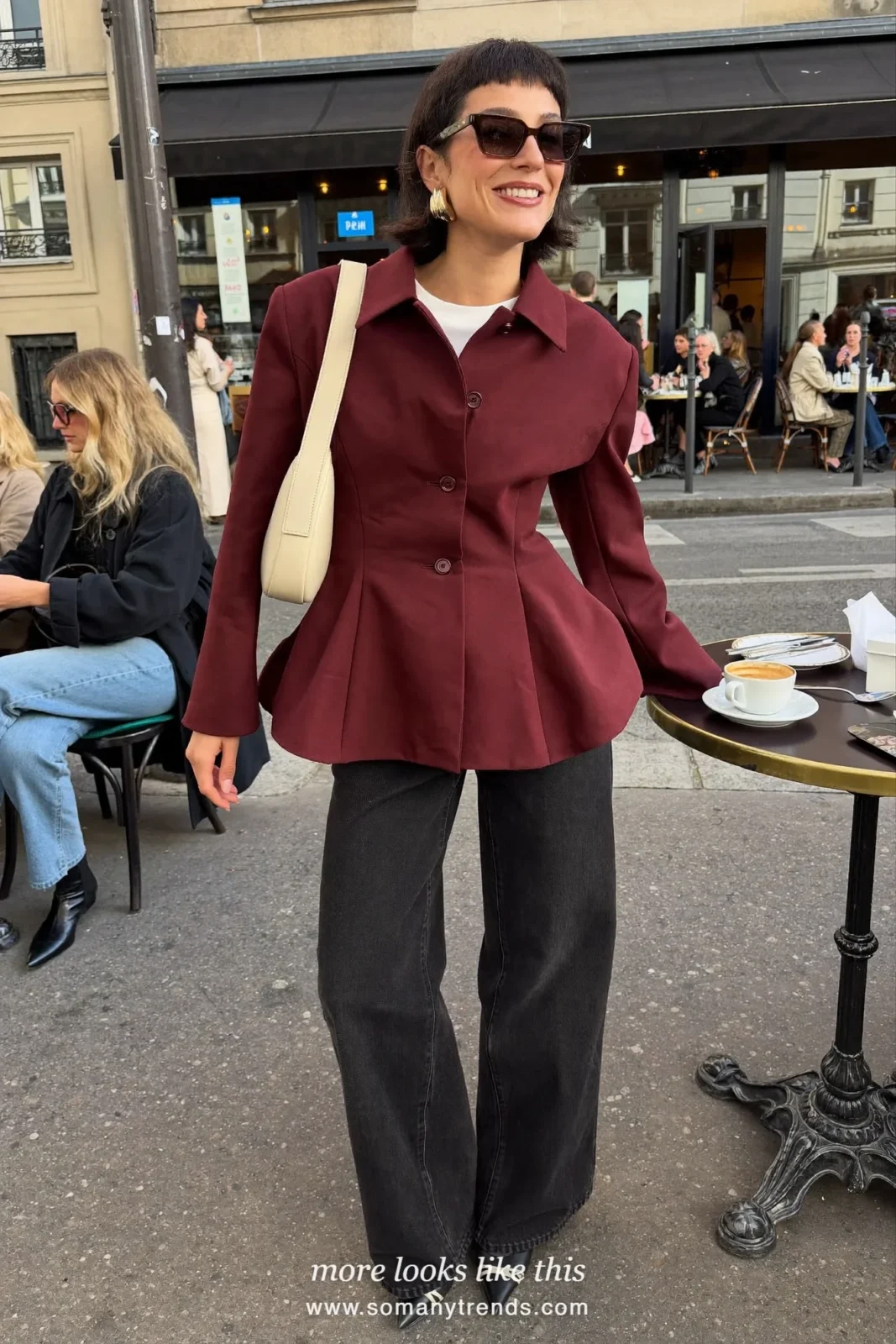 Petite woman in a burgundy peplum jacket, white tee, black wide-leg jeans, black pointed boots and a cream bag, outfit 20