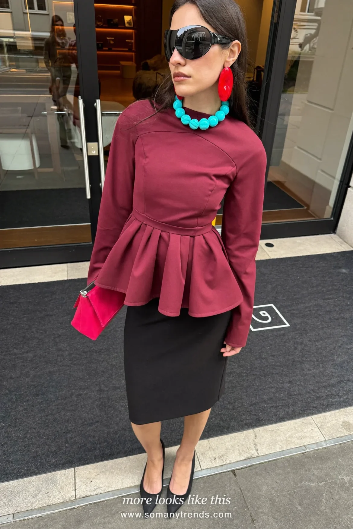 Petite woman in a burgundy peplum top, slim black skirt, black pointed pumps and a hot pink clutch, outfit 26