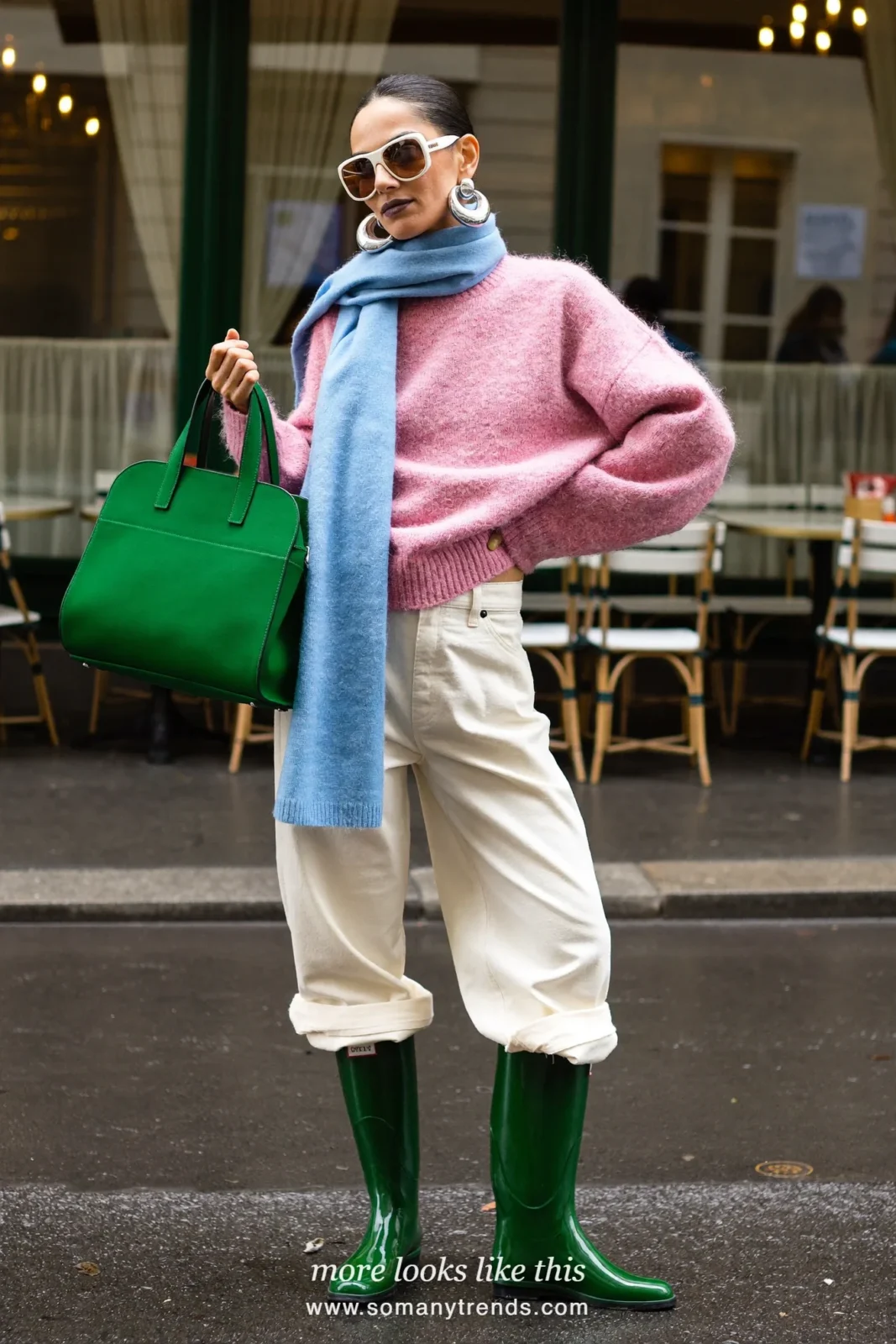 Woman in dark green short rain boots, cream straight pants, pink knit, sky blue scarf and emerald tote, outfit 16