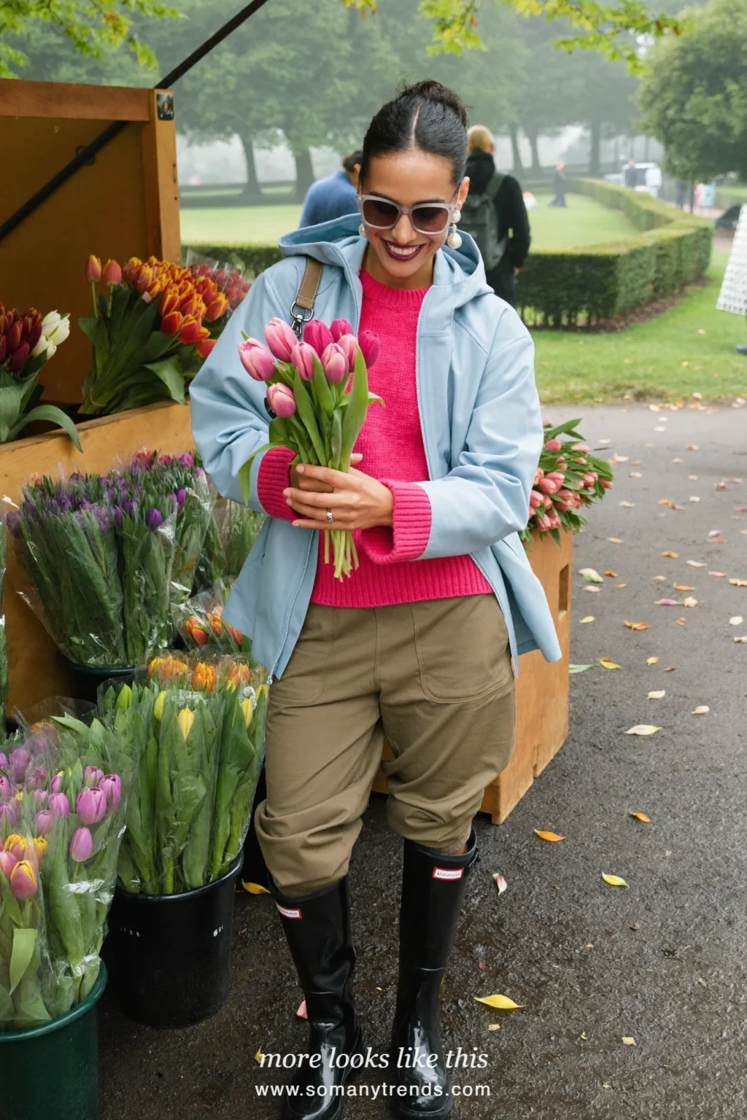 Woman in glossy black tall rain boots, khaki cargo pants tucked in, hot pink sweater and pale blue rain jacket, outfit 22