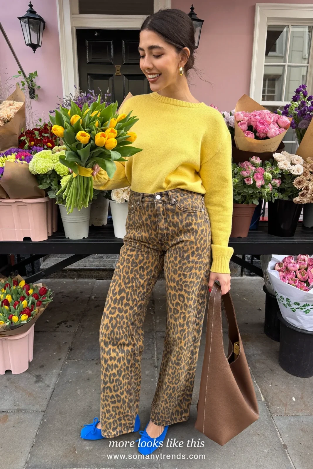 Woman in butter yellow knit sweater, leopard print wide jeans, cobalt blue ballet flats and brown leather hobo bag, outfit 4