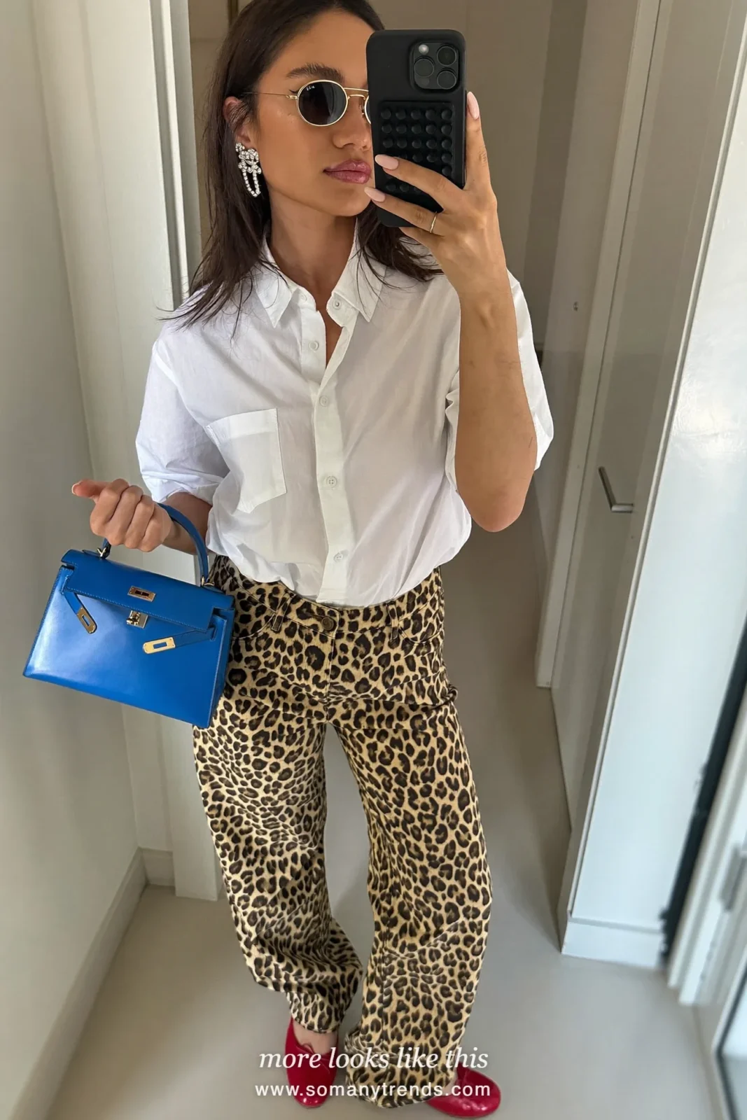 Woman in white shirt, leopard print wide jeans, cherry red ballet flats and cobalt blue top-handle bag, outfit 9
