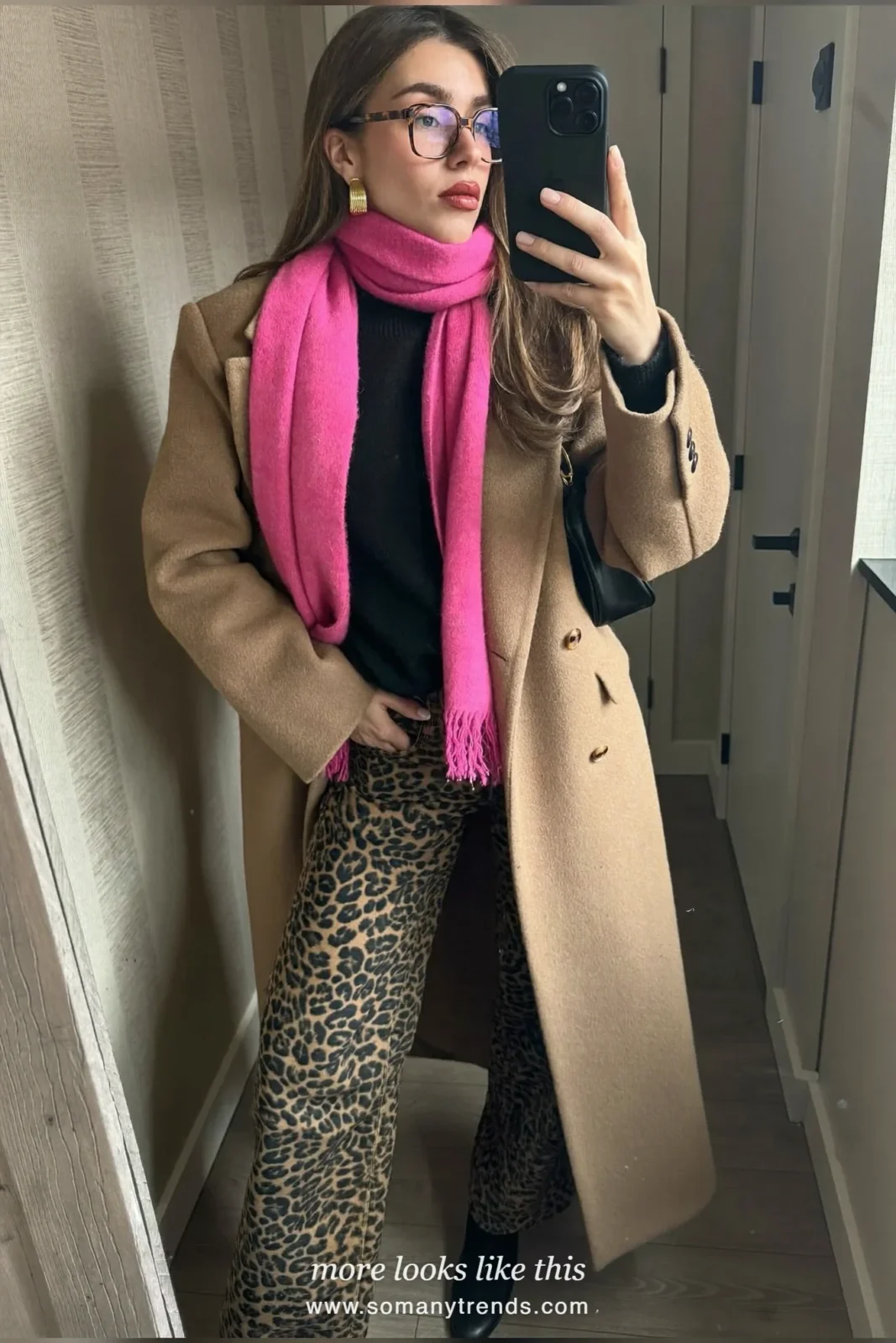 Woman in long camel coat, hot pink scarf, leopard print straight jeans and black ankle boots, outfit 18