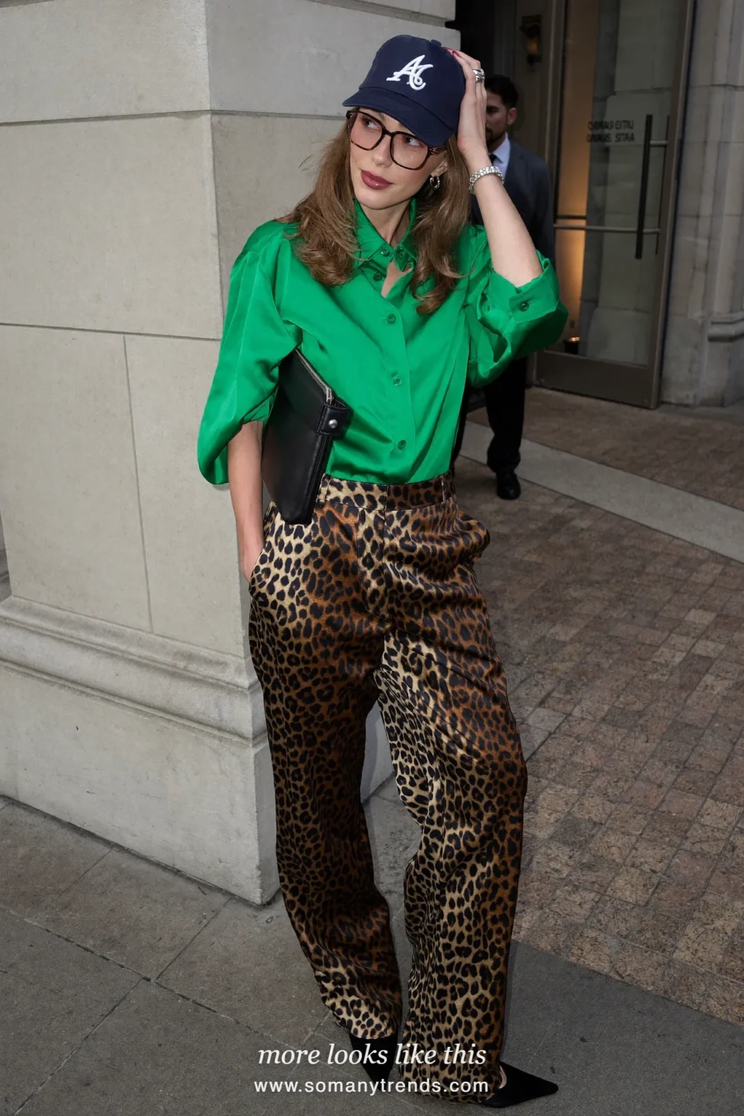 Woman in emerald green satin shirt, black and tan leopard satin pants, black pointed pumps and black clutch, outfit 23