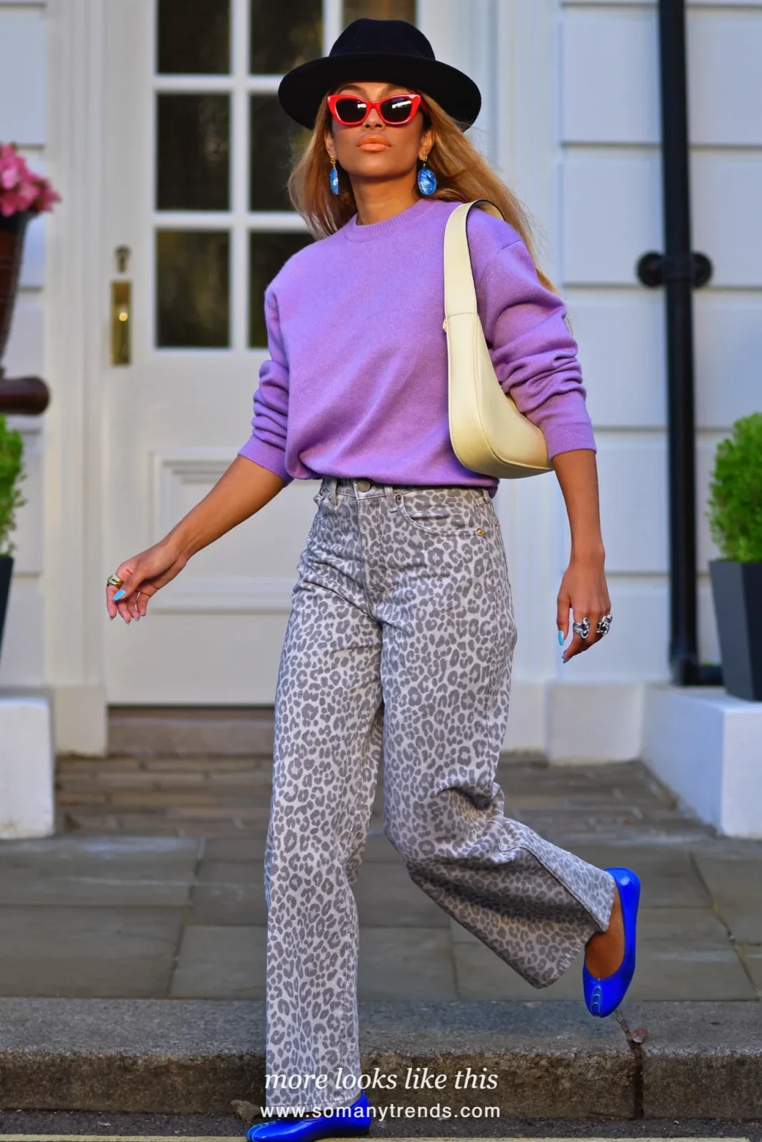 Woman in lilac knit sweater, snow leopard grey and white print straight jeans, cobalt blue ballet flats and cream bag, outfit 26