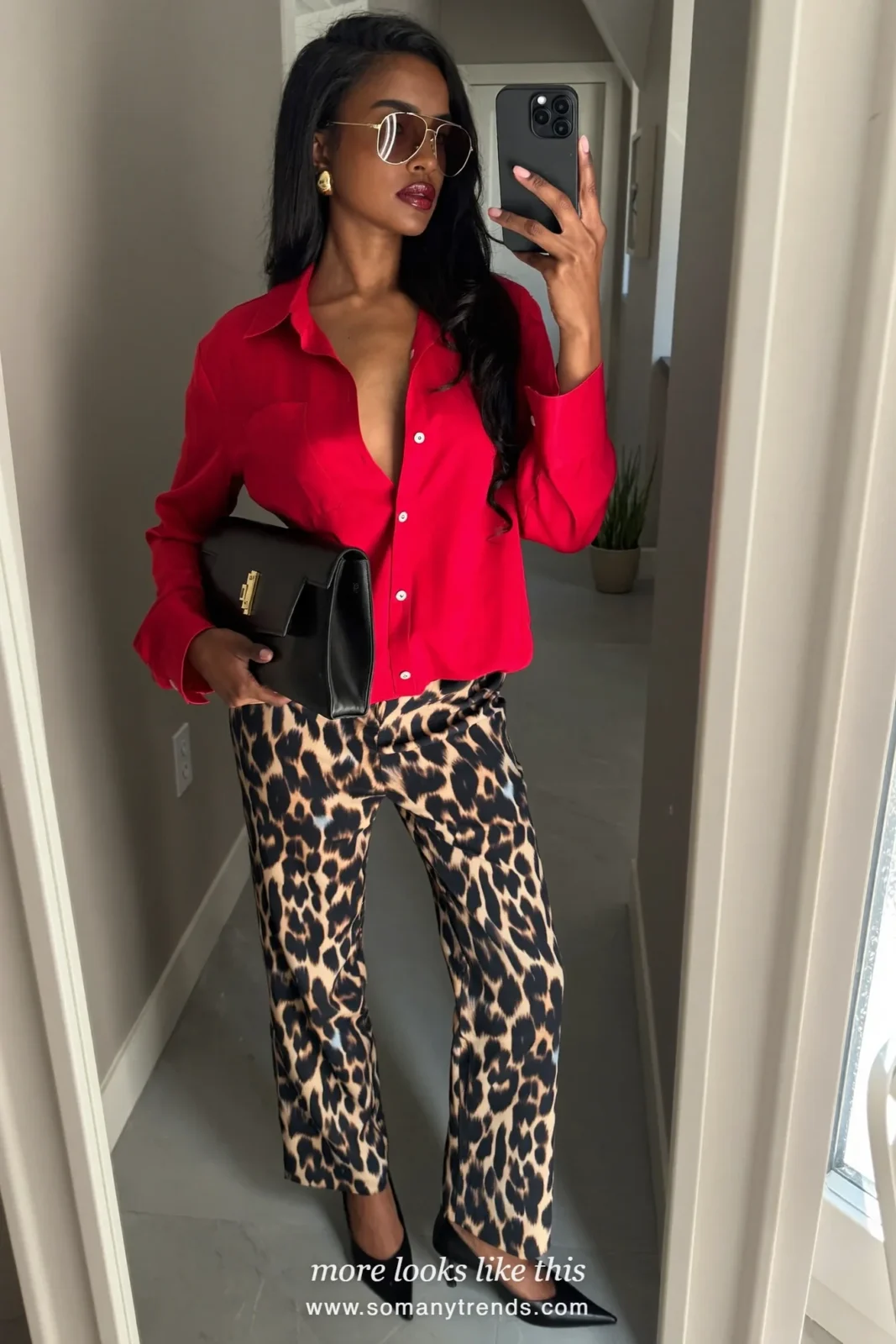 Woman in cherry red satin shirt, black and tan leopard satin pants, black pointed pumps and black clutch, outfit 27