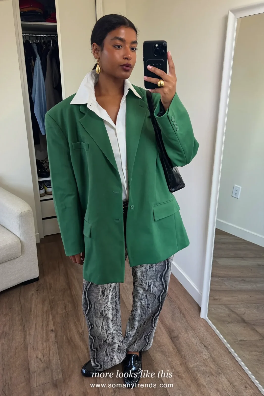 Woman in an emerald green blazer, white shirt, gray and white snake print wide trousers and black patent loafers, outfit 6