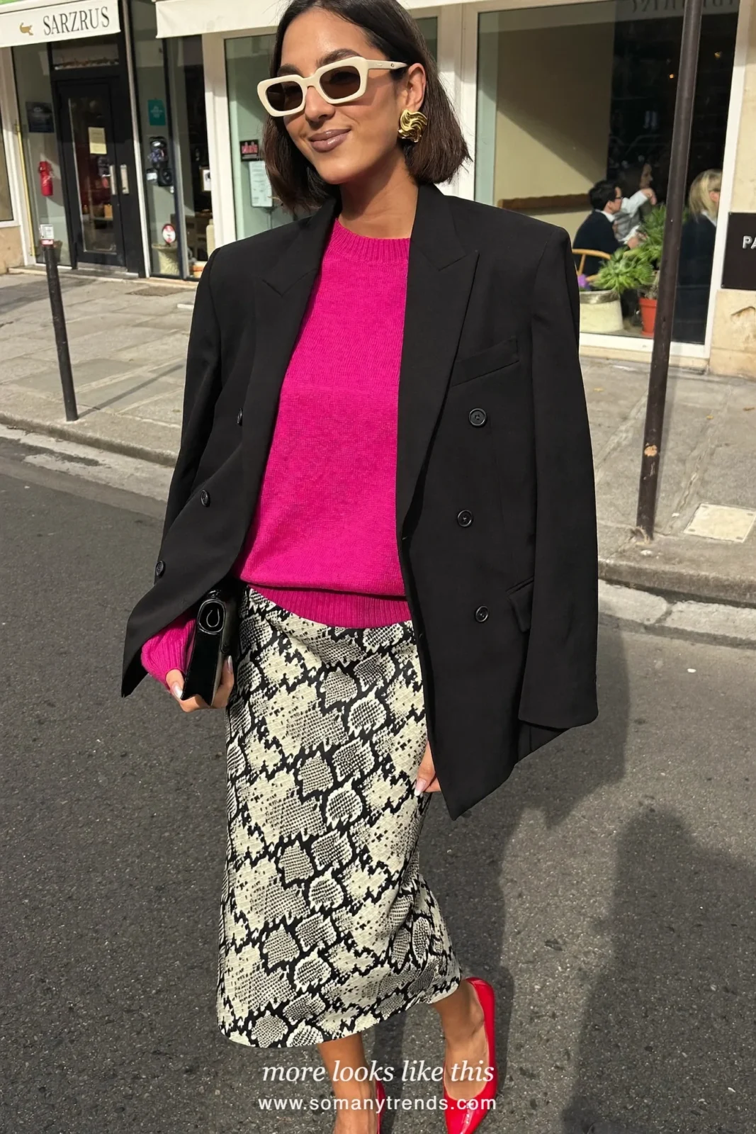 Woman in a fuchsia knit, black blazer, black and cream snake print satin midi skirt and red patent pumps, outfit 8