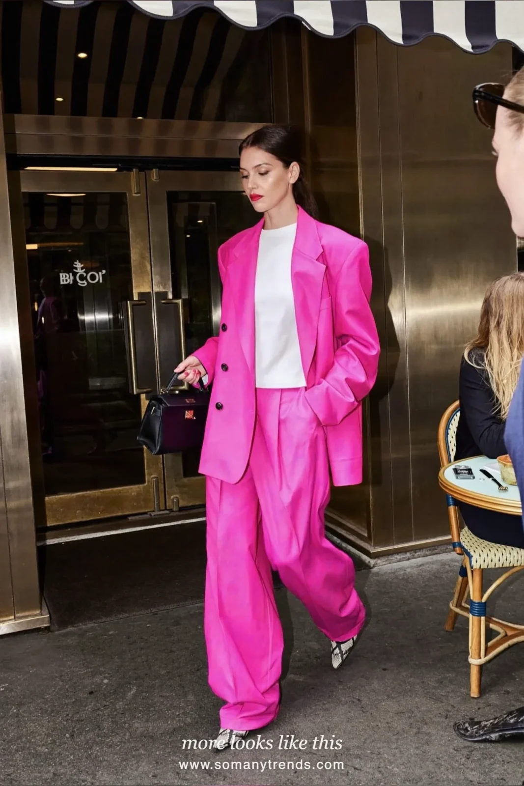 Woman in a hot pink wide-leg trouser suit, white tee and black and cream snake print pointed pumps, outfit 10