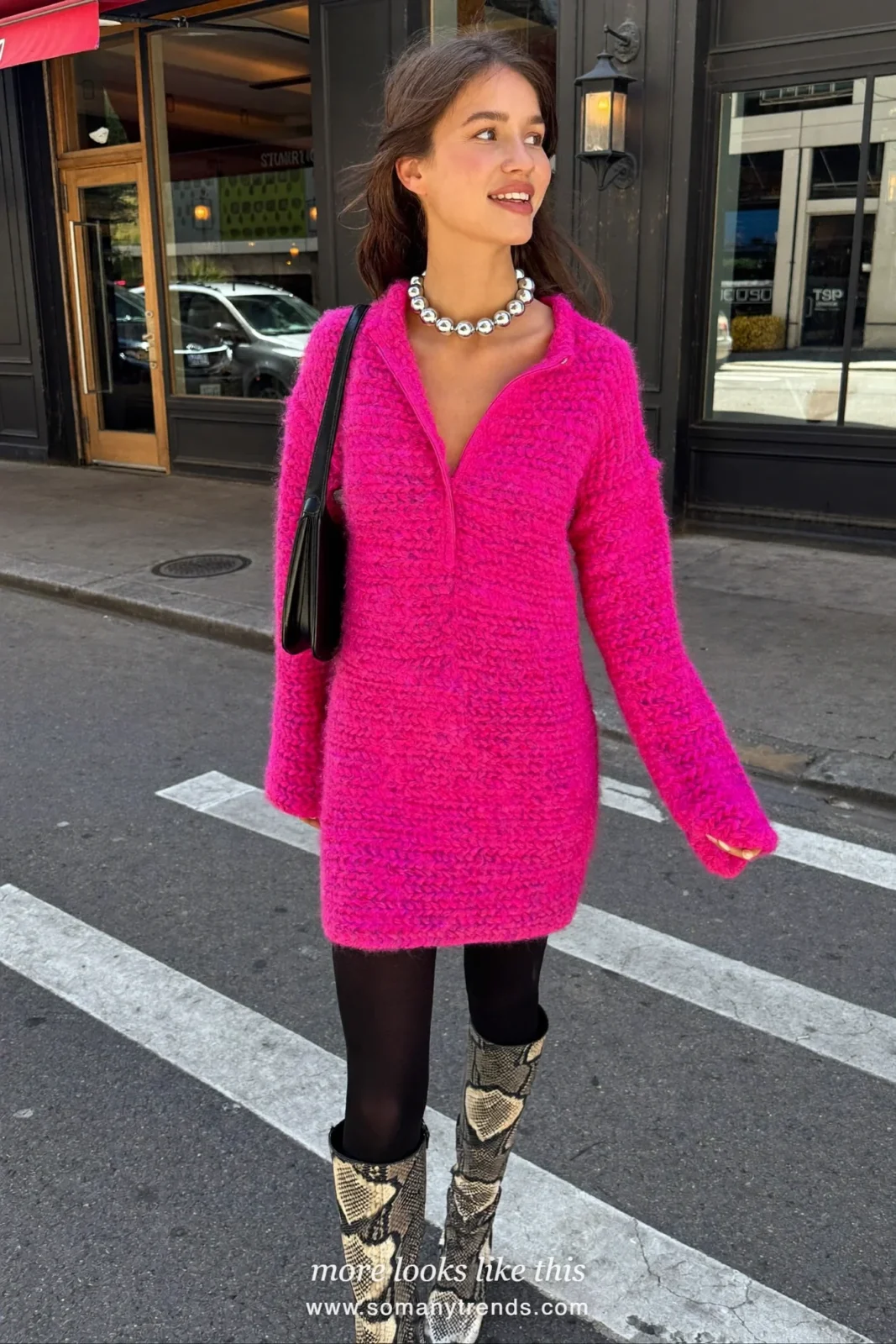 Woman in a loose fuchsia knit dress, black opaque tights, black and cream snake print knee boots and a black bag, outfit 23