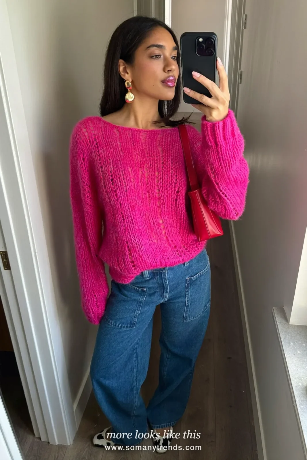 Woman in black and white cow print ballet flats with straight blue jeans, a hot pink knit and a cherry red bag, outfit 3
